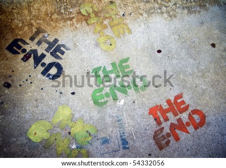 Multiply color The End Sign on the grunge cement pavement.