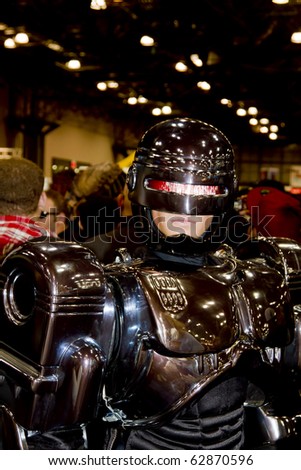 NEW YORK - OCTOBER 09: Convention goer in costume with robot attends the 2010 New York Comic Con at the Jacob Javits Center on October 9, 2010 in NYC.