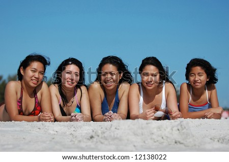 Group of ladies having fun in the sand on the beach