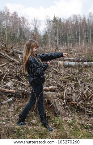 Girl playing Geocaching real-world outdoor treasure hunting game.