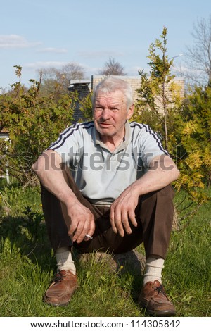 old man sitting and relax with cigarette
