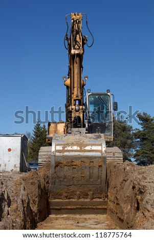 Construction of new street. excavators digging sewer trench