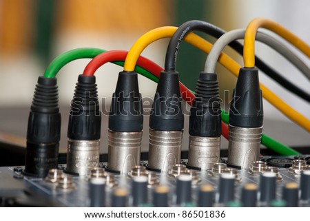 colored microphone cables connected to the sound mixer