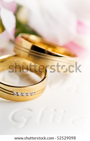 stock photo two wedding rings with flowers in the background