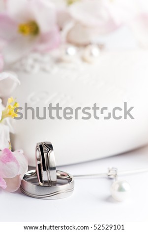 stock photo two wedding rings necklace and ear rings with flowers and a 