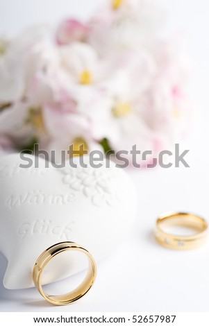 stock photo two wedding rings with flowers and a heart