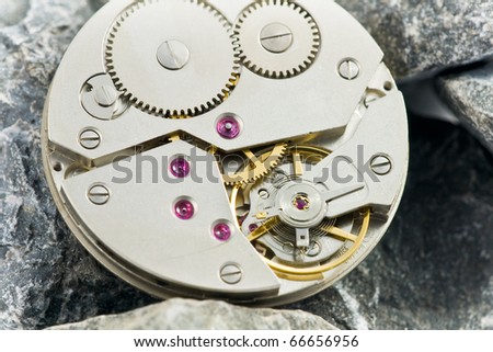 open precise clockworks with big and small cogwheels