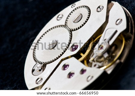 open precise clockworks with big and small cogwheels