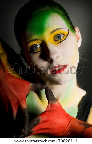 lowkey bodypainting with high contrast in colour yellow red and green