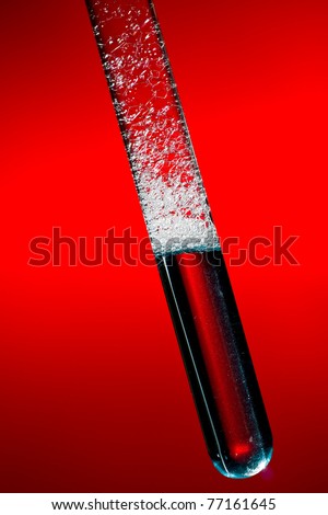 test tube filled with liquid and soap sud