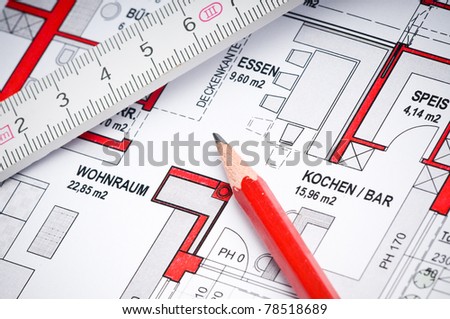 plan of a house with a ruler and a red pencil