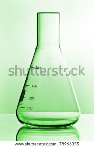 green chemistry glass on white ground with reflection
