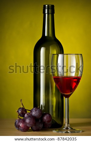 grapes with red wine glass and a bottle of wine