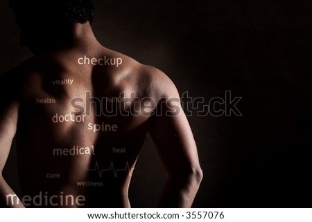 Low key image of bare male back with health concept projected onto it.