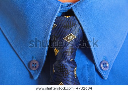 A trendy european businessman with a purple tie and blue shirt.