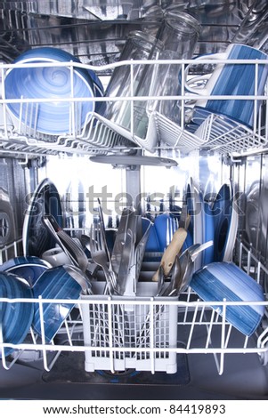 Dishwasher with knives forks and blue plates