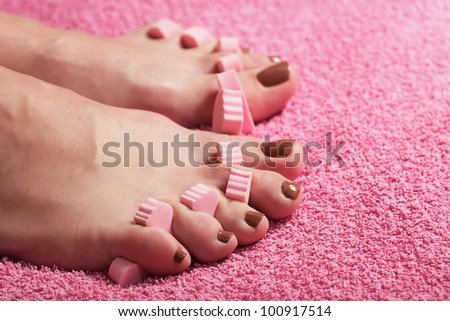 foot pedicure applying pink background