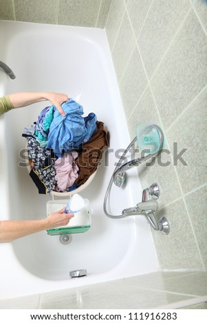 woman Pile of dirty laundry in bath washing machine green bathroom