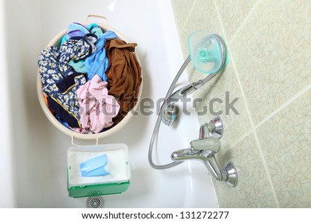 Pile of dirty laundry in bath washing machine green bathroom