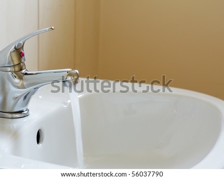 Bathroom interior with white sink and faucet - mixer tap