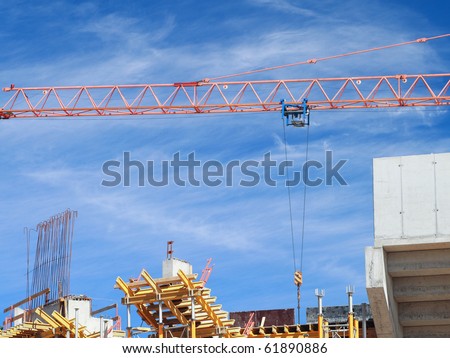 The crane elevating against the blue sky