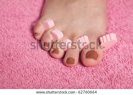 foot pedicure applying pink background