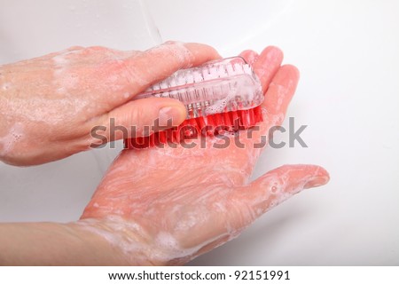 Woman wash red soapy hands in bathroom soap nail brush person scrubbing nails