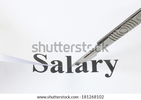 Scalpel cutting through the word Salary. Concept denoting a cut in income or salary caused by economic troubles and a lowering of standard of living.