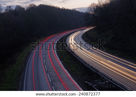 Traffic on a main road in the UK in winter at sunset. Travel concept.
