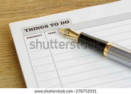 Things To Do list with a fountain pen, on a desk.Business concept.