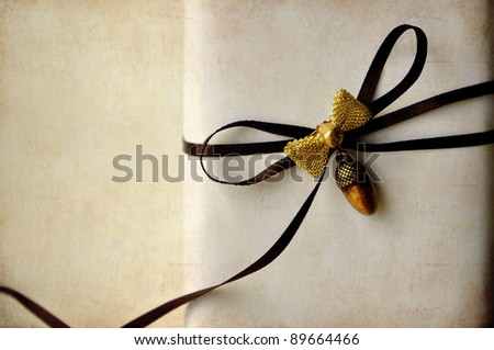 Luxurious Gift Box with brown ribbon and brooch on vintage background