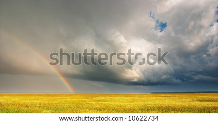 Landscape with storm clouds and rainbow