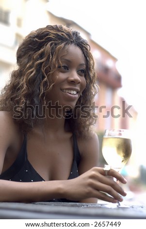 Young African American girl drinking wine