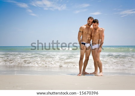 Two men standing at the beach