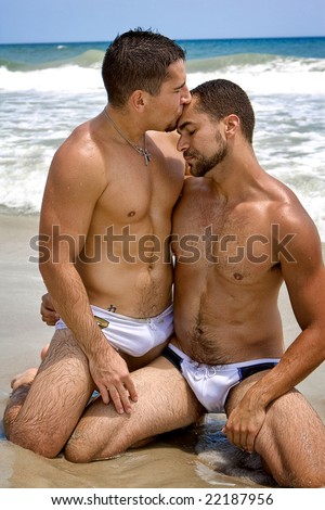 stock photo Two gay men at the beach kissing