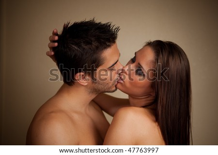 Woman and man kissing, both shirtless