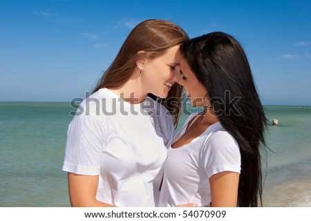 stock photo Lesbian couple standing on a beach