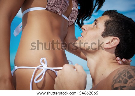 stock photo Man undressing woman from swimsuit