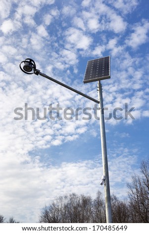 Stand-alone street light with solar battery on sky background. Renewable Energy