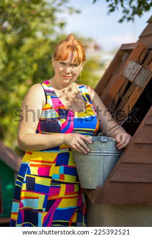 Portrait of a rural woman at well