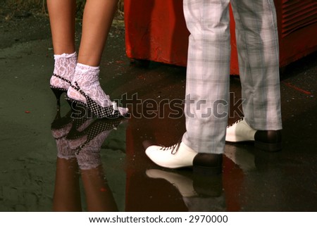 Foots of the man and the woman in a retro of footwear