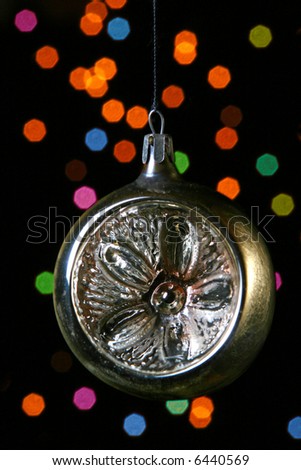 Christmas ornament on a black background with patches of light