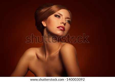 Closeup Portrait Of Beautiful Young Woman With Creative Makeup And Hairstyle Against Brown Background