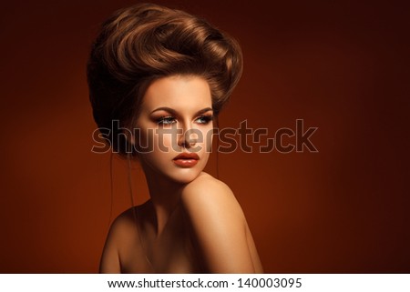 Closeup Portrait Of Beautiful Young Woman With Creative Makeup And Hairstyle Against Brown Background