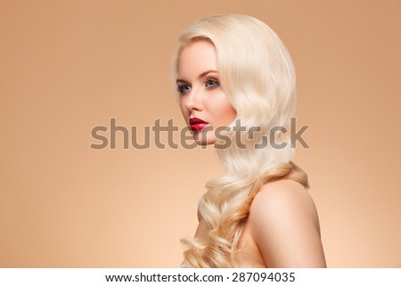 closeup portrait of beautiful girl with bright make-up and long blonde curls