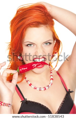 stock photo portrait of beautiful and sexy redhead woman biting hot chili