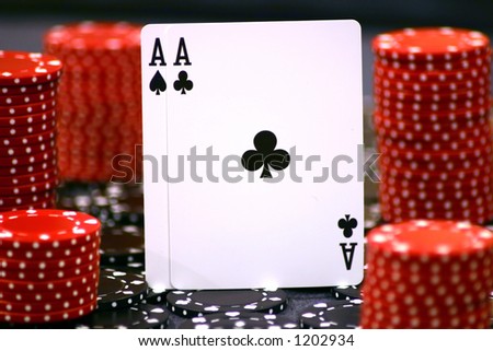 Pair of aces surrounded by red and black chips, selective focus