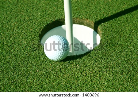 Golf ball about to go in hole, space on ball for logo