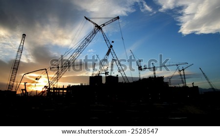 Construction Site Sillouhette with Multiple Cranes at Sunset