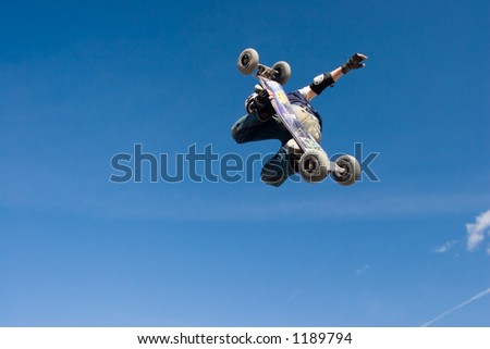 A mountainboarder in mid air with a deep blue sky in the background